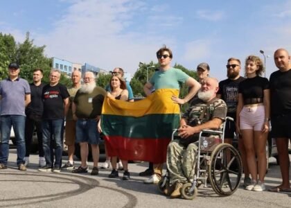 Mažasis Konvojus volunteers with Lithuanian flag supporting Ukraine
