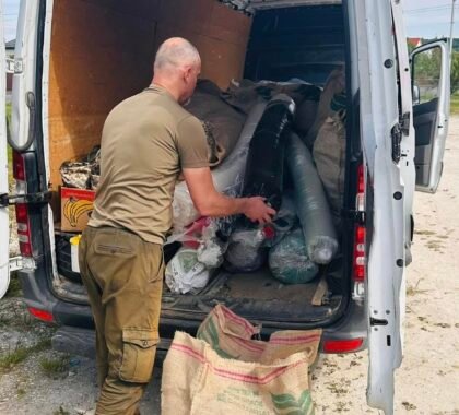 Volunteers loading humanitarian aid into a minibus for Ukraine