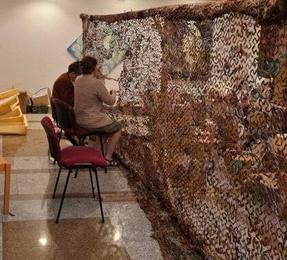 Volunteers weaving camouflage nets for Ukraine